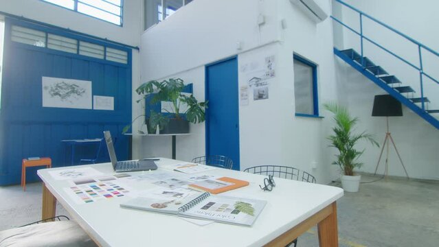 Zoom Shot Of Office Table With Sketches And Catalogs In Architecture Firm With No People