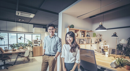 Obraz premium Asian couple working and researching online on laptop, Cheerful loving young couple using laptop analyzing work. Beautiful couple working on a tablet at office. Generative AI..
