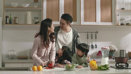 happy asian family enjoying time together in kitchen at home - Powered by Adobe