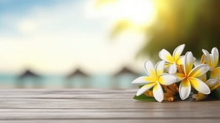 Fototapeta na wymiar Frangipani flower on wooden table. Frangipani flowers on a summer beach background