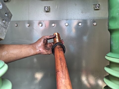 Jakarta, Indonesia, 14 July 2023; Removal of the 20kv secondary bushing conductor inner side of the transformer