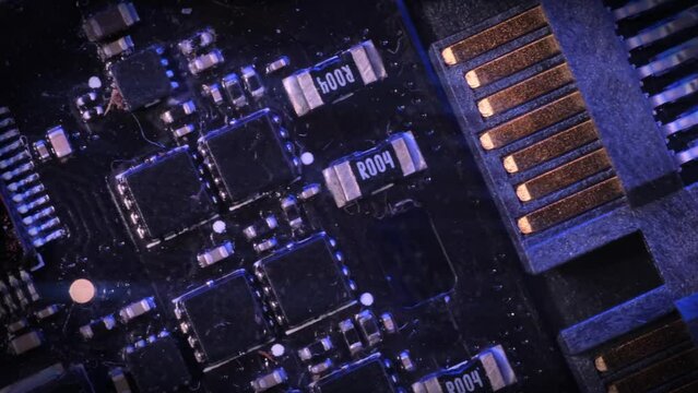 Mainboard, motherboard close up, tracking shot, dark vignette. Modern nano-digital technologies chips, deficit semiconductors and microchips. 