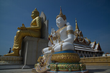 Outdoor large Buddha golden and white in the sitting position beautiful enshrined in front of the...