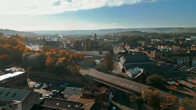 Aerial footage of the large market town centre of Dewsbury in West Yorkshire in the UK showing the historical town centre and townhall.