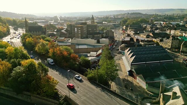 Aerial footage of the large market town centre of Dewsbury in West Yorkshire in the UK showing the historical town centre and townhall.