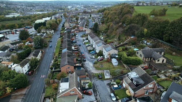Aerial footage of the large market town centre of Dewsbury in West Yorkshire in the UK showing the historical town centre and townhall.
