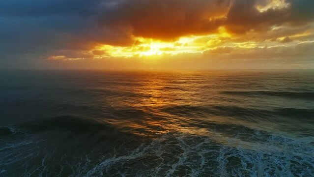 Aerial view on big waves of Atlantic ocean and dramatic sunset sky, 4k