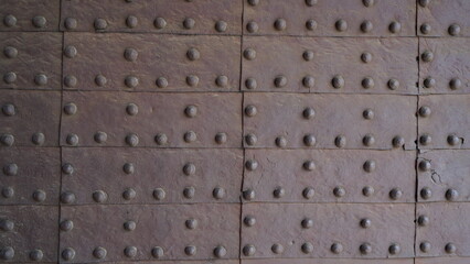 Texture of the old gate with metal rivets