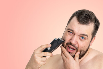 unshaven young man perfect skin hold electric razor shaving, isolated. Skin care healthcare...