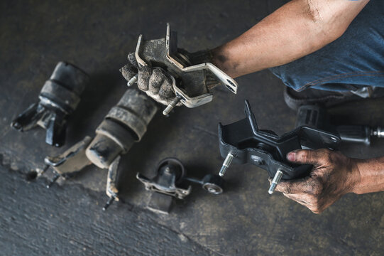 Auto mechanic replacing car engine mounts ,bad engine mount repair and service.