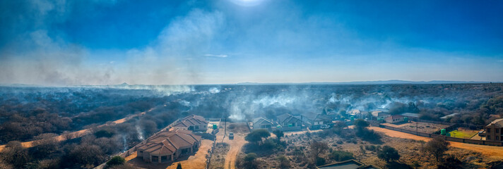bush fire uncontrolled in Gaborone, Botswana, near the residential area with houses