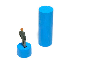 Miniature tiny people toy figure photography. Business gap concept. A businessman standing above...