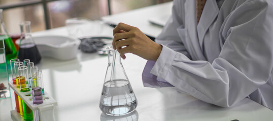 Young female scientist testing tube chemical ingredient to conduct research in laboratory,test...