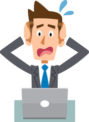パソコンの前で頭を抱えるビジネスマン
