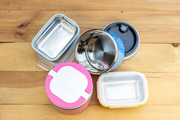 New empty stillness steel lunch boxes on a wooden background