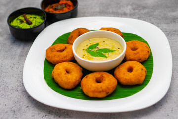 selective focus of South Indian famous food "Medu Vada" with Sambar and coconut chatney.