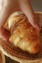 hand holding croissant