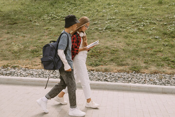 teenage boy and girl outdoors portrait, communicating and walking together