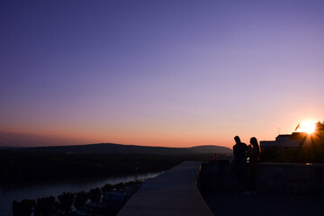 Silhouettes of Lovers on the Balconies of Bratislava Castle at Sunset - Slovakia