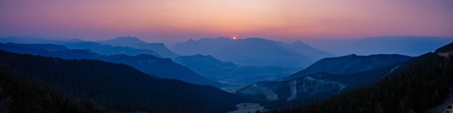 Panorama overlooking sunset of Dead Indian Pass near Cody, Wyoming during the Canada wildfires in spring of 2023
