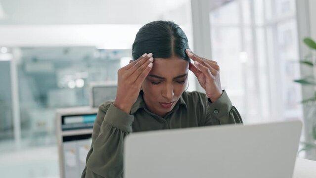 Headache, stress and business woman in office with tax, problem or brain fog while working on laptop. Anxiety, vertigo and Indian manager with temple massage for migraine, crisis or glitch 404 error