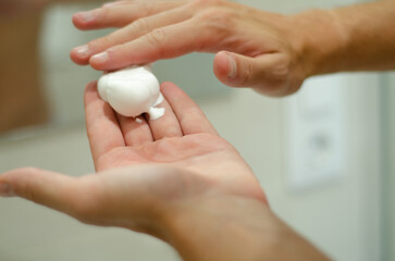 closeup of shaving foam on a man hands. Selective focus