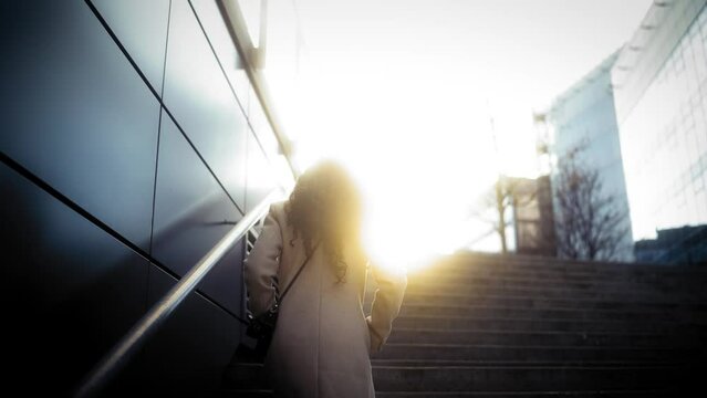 Silhouette Of A Woman Walking Up The Stairs