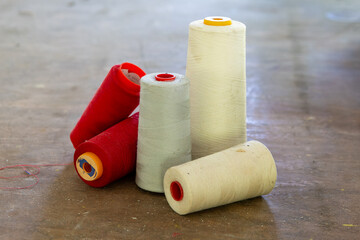 old spools of yarn on a table in an abandoned house