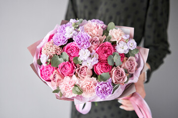  Florist woman creates beautiful bouquet of mixed flowers. European floral shop concept. Handsome fresh bunch. Education, master class and floristry courses. Flowers delivery.
