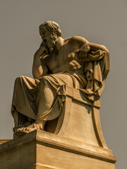 Sorates marble statue, the ancient Greek philosopher, isolated on plain sky background. Travel to Athens, Greece.