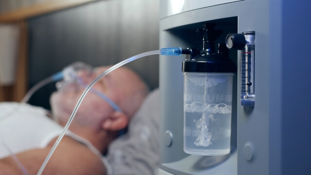 Working oxygen humidifier for nasal cannula, closeup oxygen generator, low oxygen saturation, bubbling water filter. Personal O2 generator for home usage. Oxygen concentrator