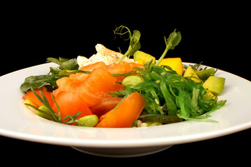 Poke bowl with fresh salmon, chukka salad, beans and caviar. A plate of healthy food on a light...