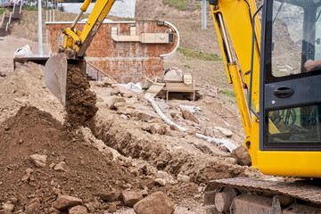 Excavator works in the highlands. Makes a trench for communications. water and electricity. in the...