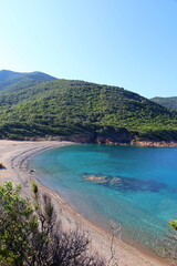 Fototapeta na wymiar Beautiful secluded beach with azure sea water near Girolata bay, Corsica island, France