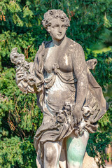 Obraz premium Potsdam, Germany - Old statue of a sensual Renaissance era woman after bathing in the city park and gardens of Potsdam, details, closeup.