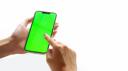 Mockup image, woman holding black smartphone and finger pointing on blank green screen isolated white background.