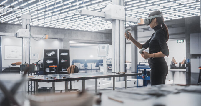 Female Car Designer Wearing Virtual Reality Headset and Using Controllers to Work on a Concept Car Made Out of Plasticine Modeling Clay. Talented Designer Working in VR Set to Analyze the Vehicle