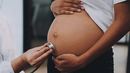 Happy pregnant woman visit gynecologist doctor at hospital or medical clinic for pregnancy consultant. Doctor examine pregnant belly for baby and mother healthcare check up. Gynecology concept.