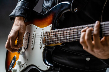 Close up hand playing electric guitar. Musician playing guitar, live music. Man playing guitar....