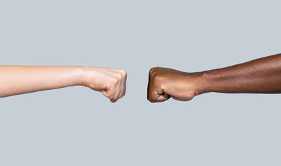 Friendship, team, good work. Multicultural friends giving fist bump to each other. Black African American race male and woman hands giving a fist bump, multiracial diversity, immigration concept