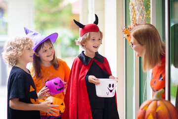 Kids trick or treat. Halloween. Child at door.