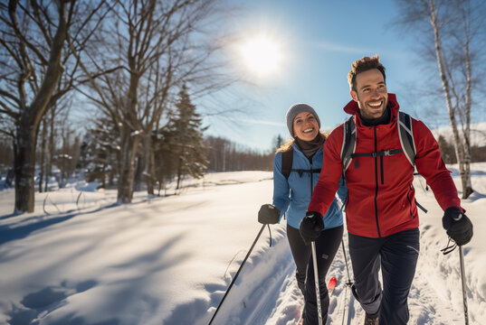 Sporty couple cross country skiing on a sunny winters day. Active lifestyle and fitness during the winter months. Shallow field of view