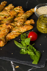 Bread sticks with sesame and tomato with pesto sauce