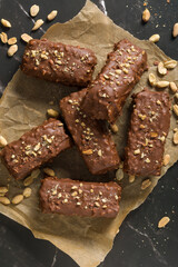 Chocolate sticks with peanuts on a dark background