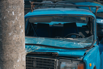 Broken bumper and hood of a car as a result of a collision with a pole, close-up. The car crashed into a lamp post. car accident