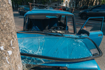 Broken bumper and hood of a car as a result of a collision with a pole, close-up. The car crashed into a lamp post. car accident