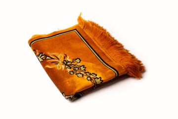 Photo of an orange prayer rug isolated on a white background