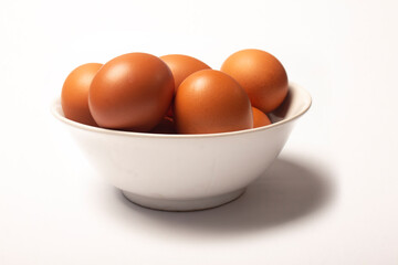 Photo of eggs in bowl isolated on white background