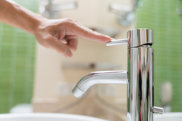 Save water. Volunteer keeps turning off the running water in the bathroom to protect environment....