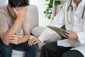 man with mental health problems is consulting. psychiatrist is recording the patient's condition...